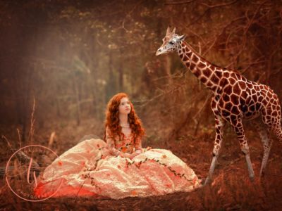 Fantasy portrait of a child in a ball gown next to giraffe
