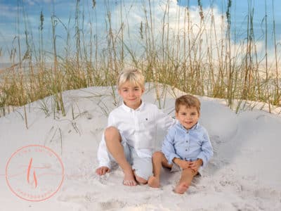 Destin photographer capturing portrait of kids on sand dune