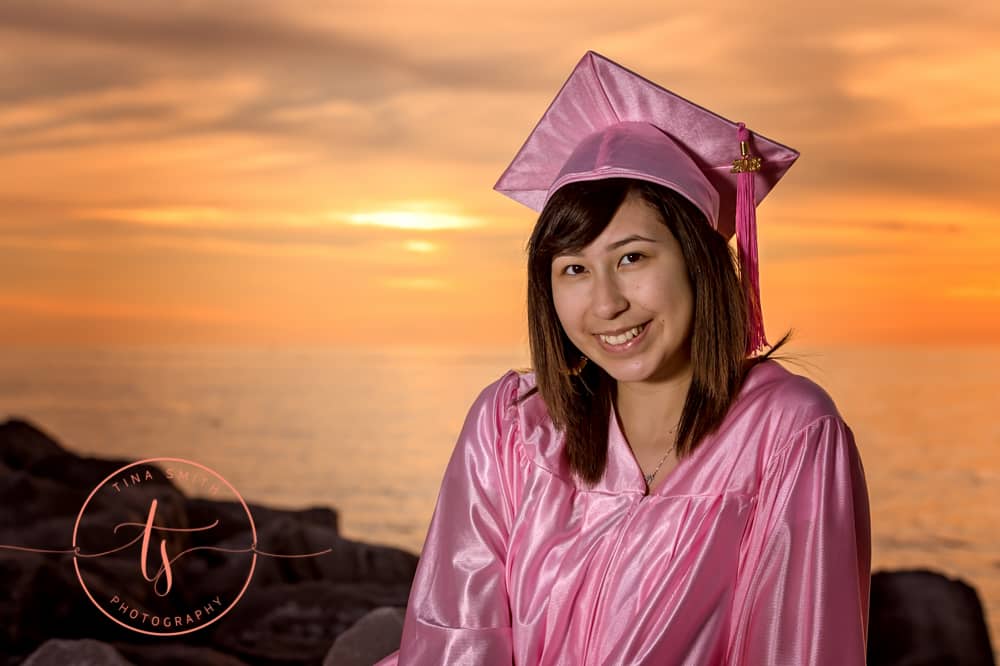 destin florida photographer graduating girl wearing pink cap and gown