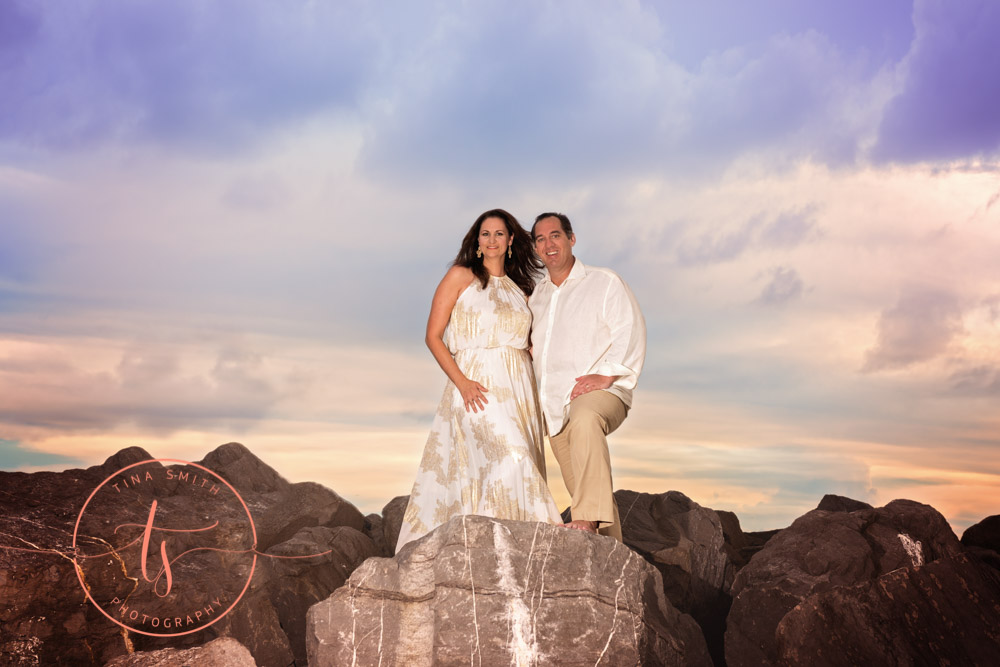couple standing on rock on beach in destin