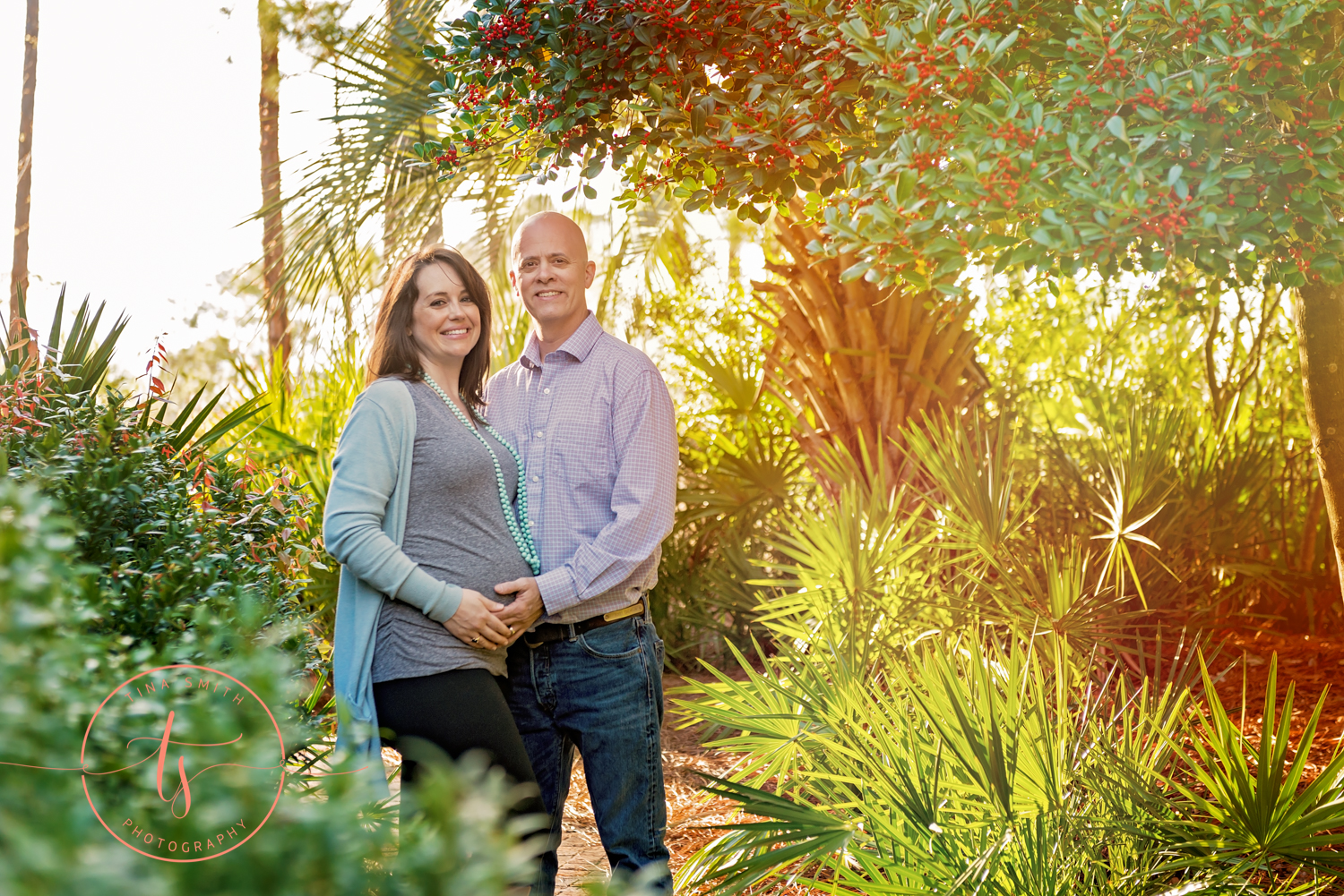 maternity couple standing in trees at baytowne wharf