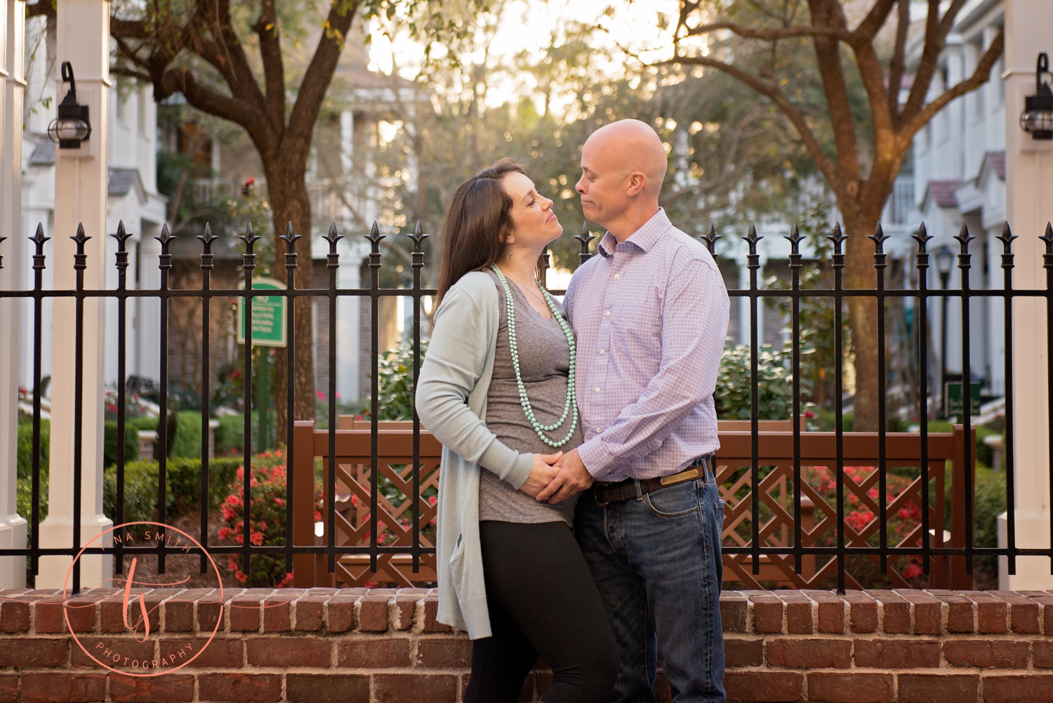 maternity couple posing at baytowne wharf