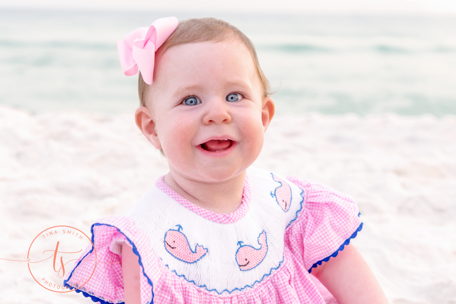 red-haired girl in pink dress sitting on beach in destin