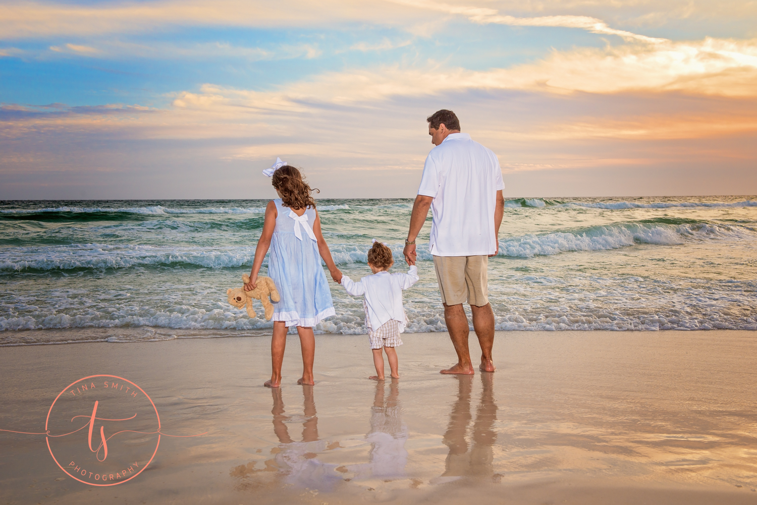 dad and daughters holding hands on watersound beach 30A