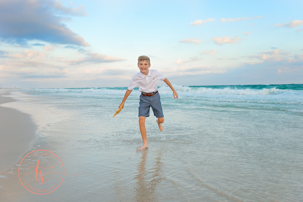 boy splashing on beach in destin