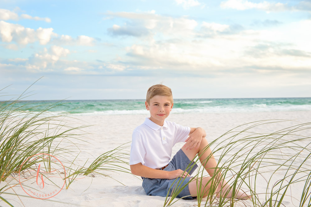 boy sitting on beach in destin