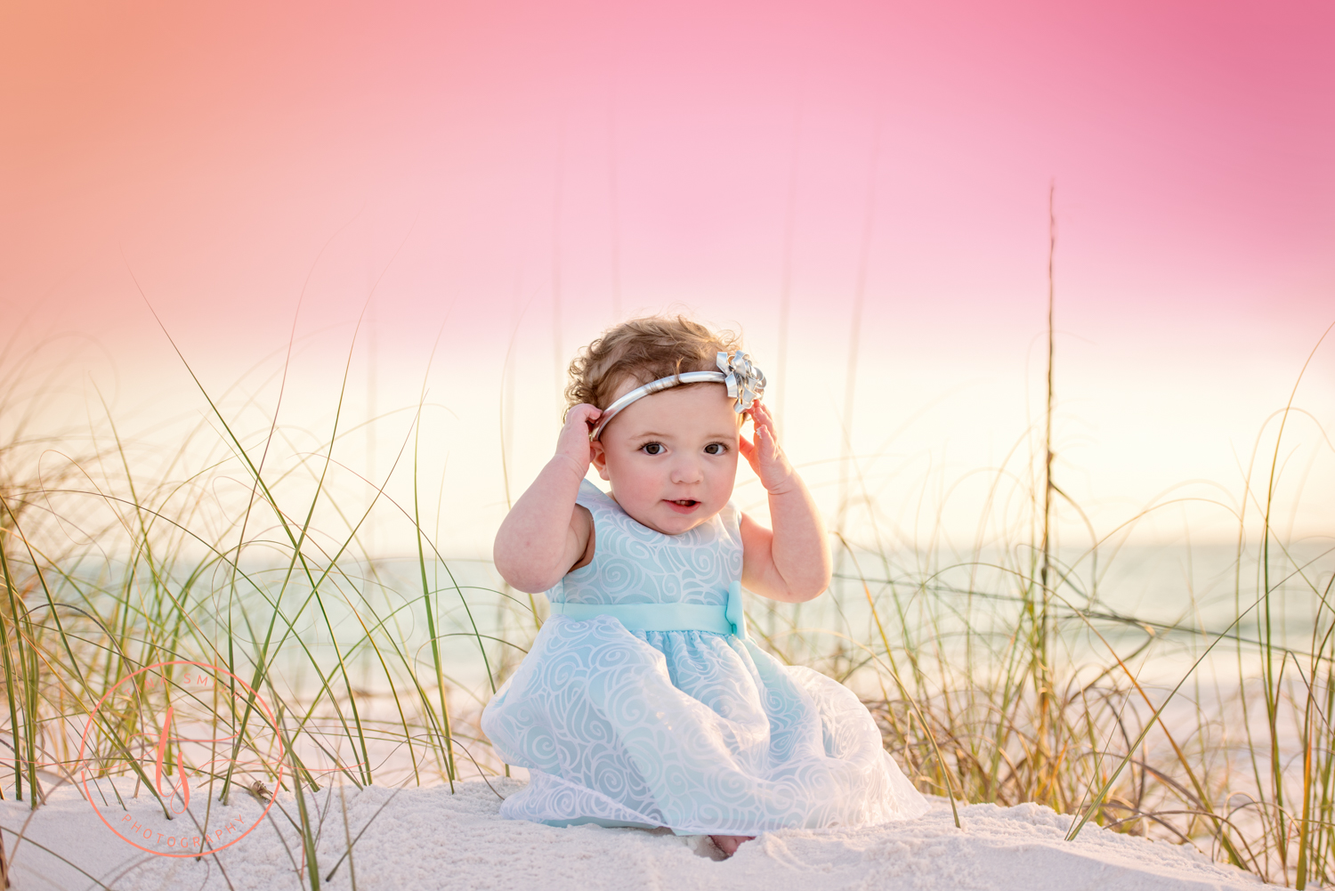 baby girl in lavender dress sitting on beach in destin 