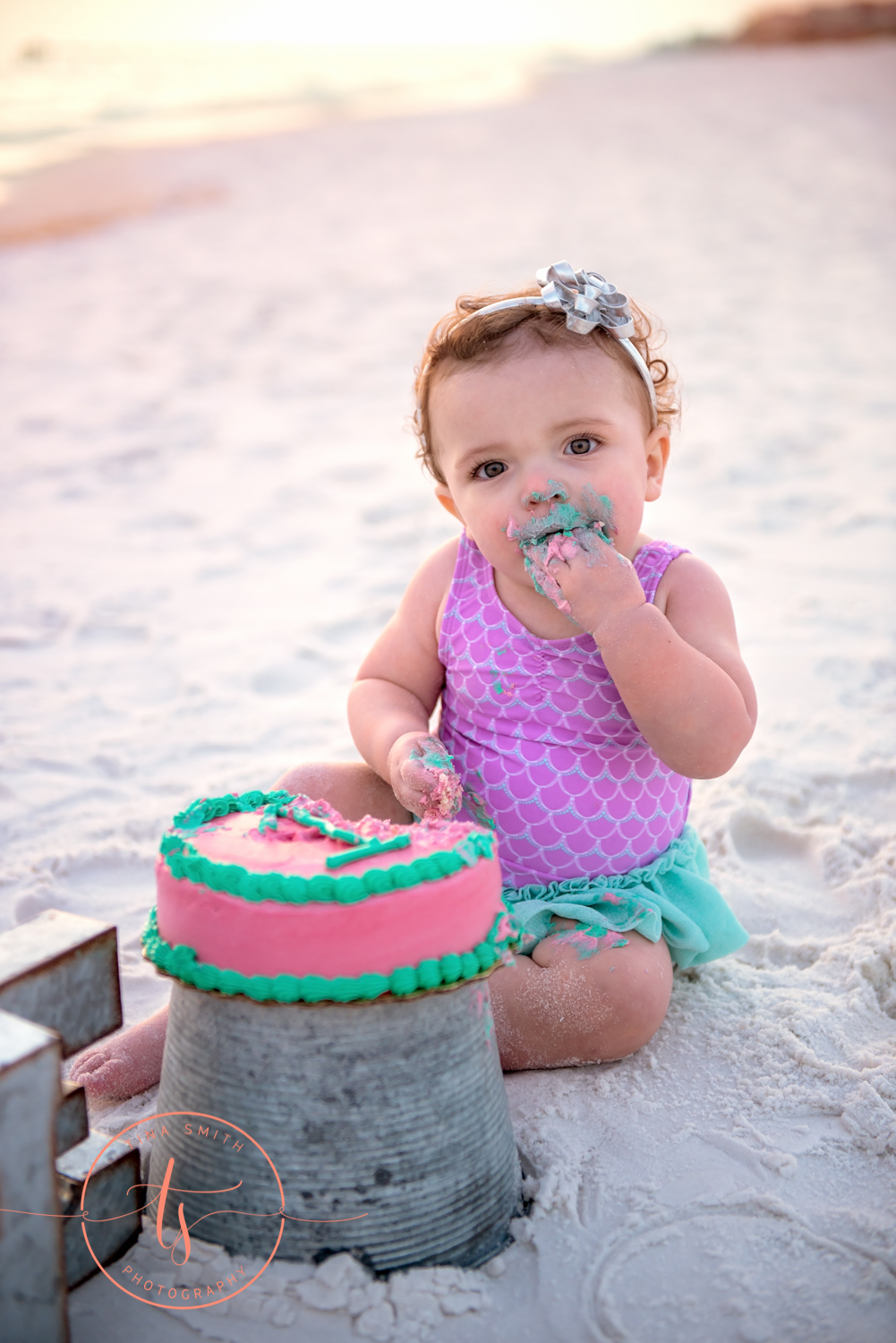 baby eating cake on beach in destin for portraits