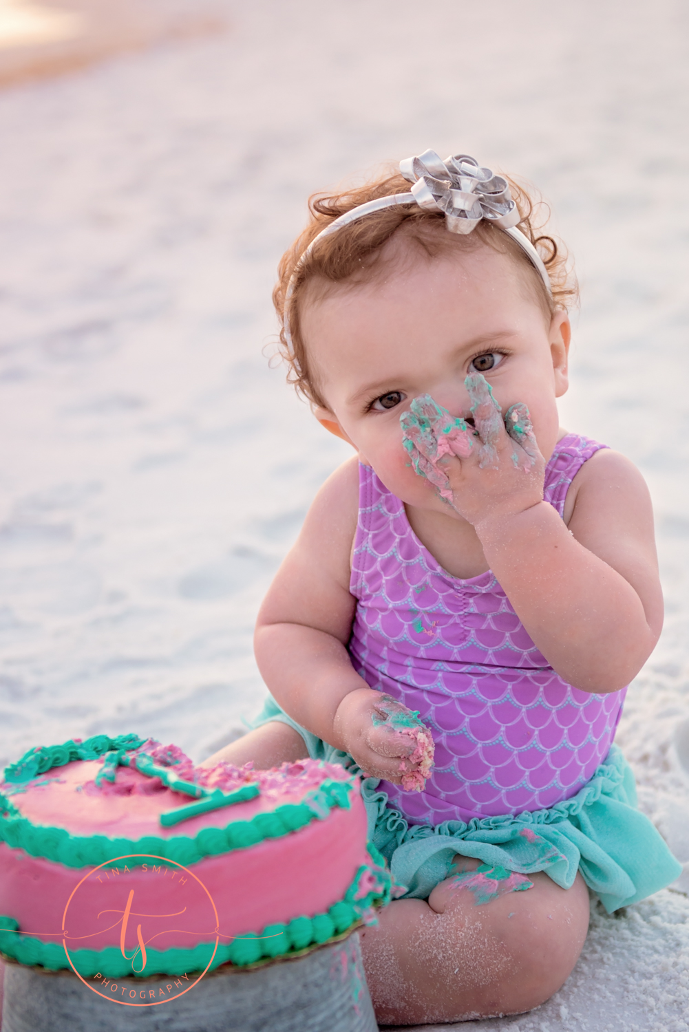 baby smashing cake into her face on beach in destin