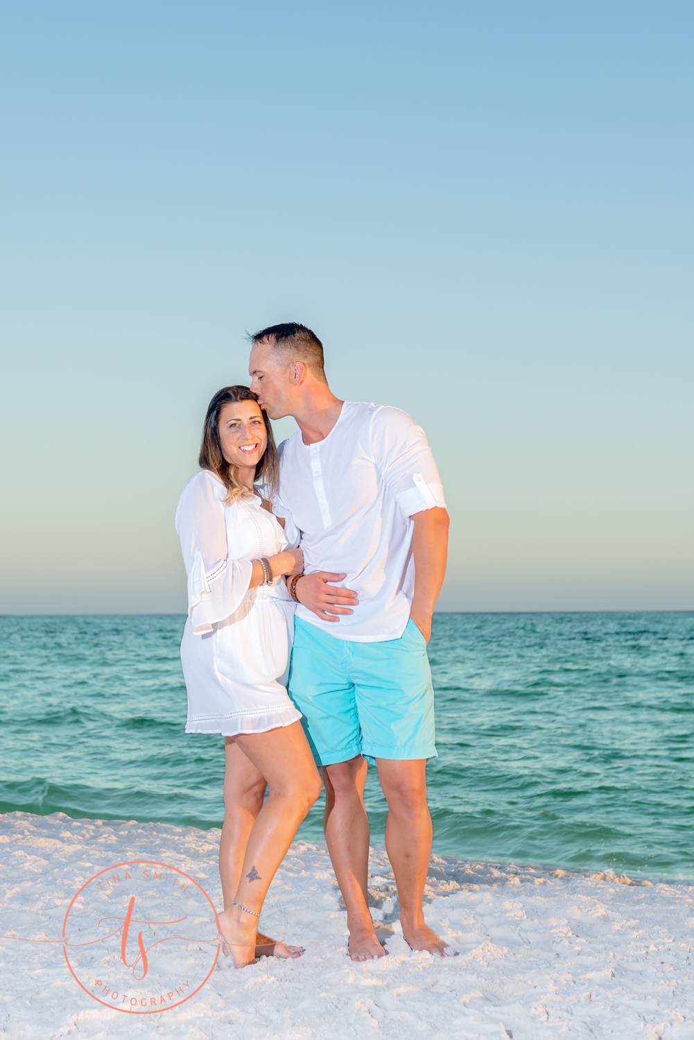 couple posing on beach for portraits