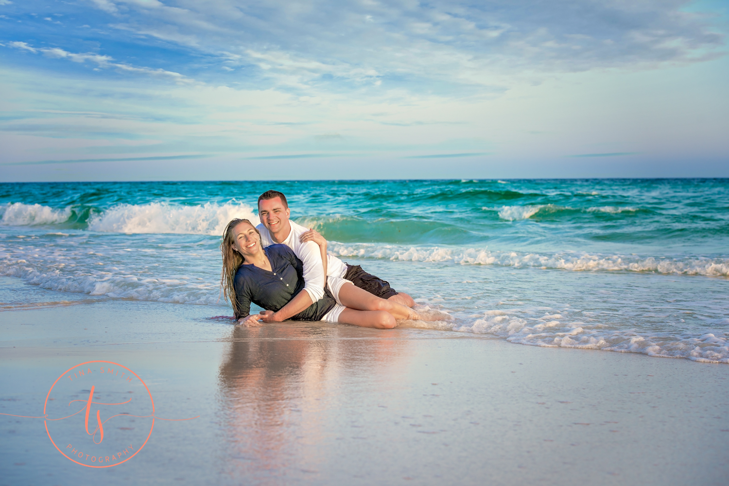 couple in the water on beach in destin posing for engagement photography