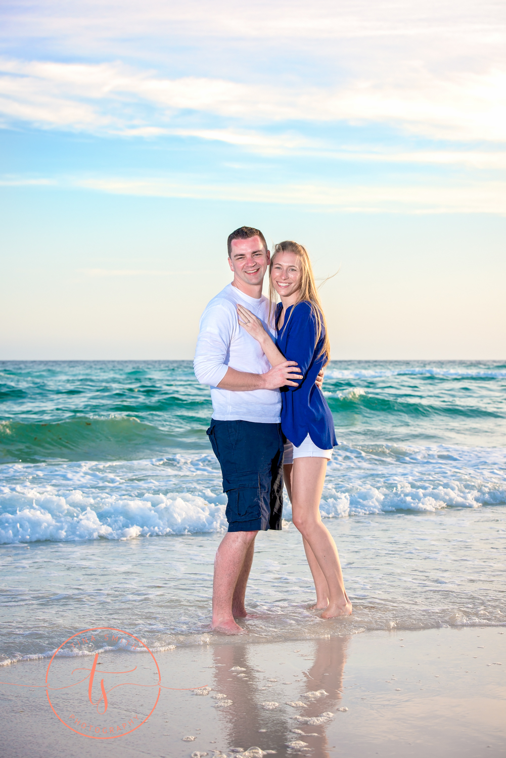 couple hugging showing off engagement ring