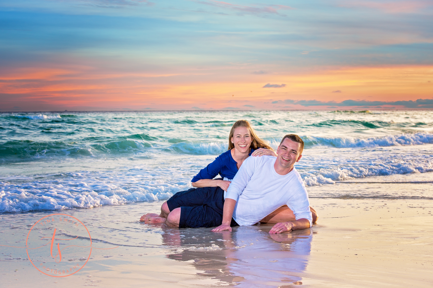 engaged couple posing for portraits in water