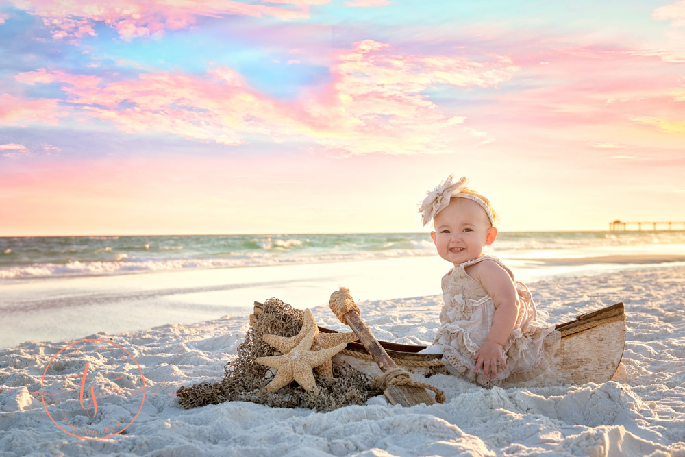 girl sitting in boat on beach in destin