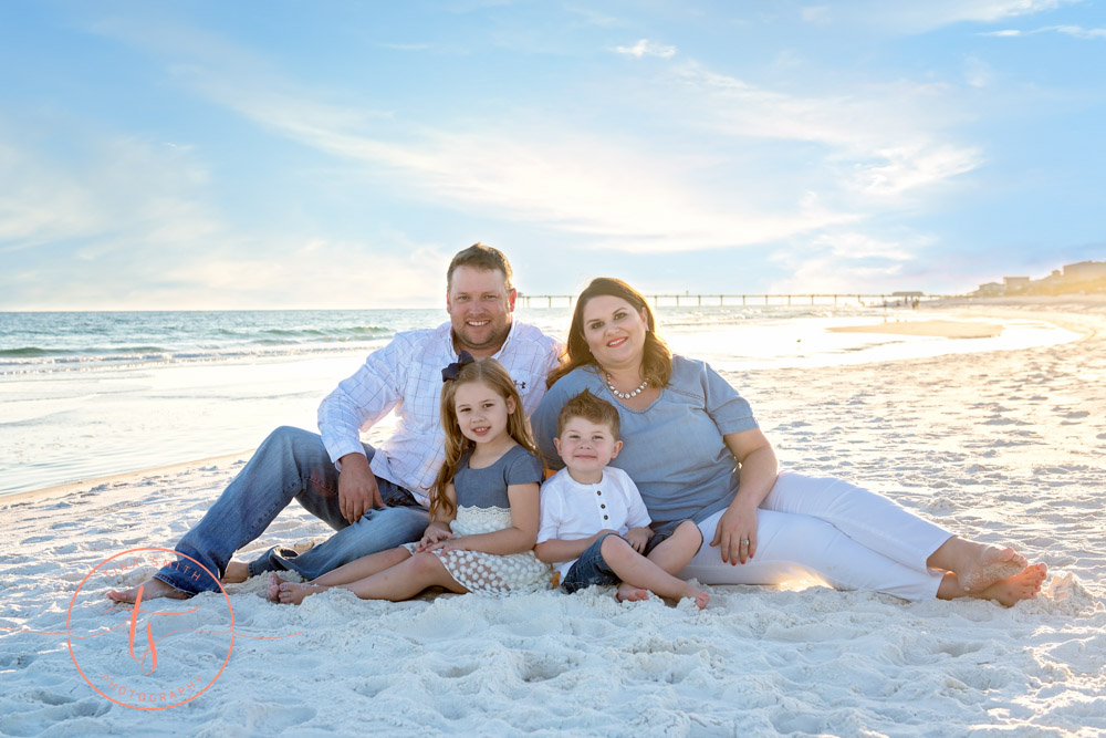 family sitting on beach for destin family beach photography