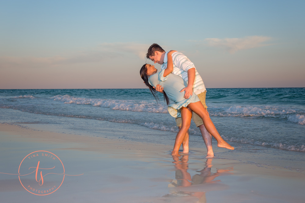 couple on beach in destin posing for photographer