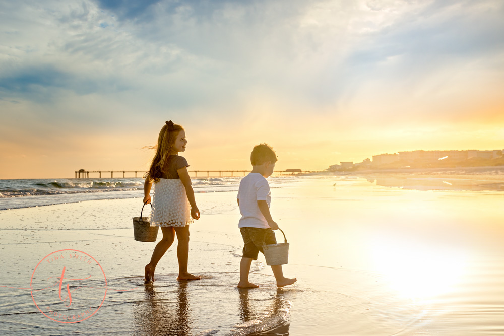 kids walking down beach at sunset holding buckets for family beach photography in destin