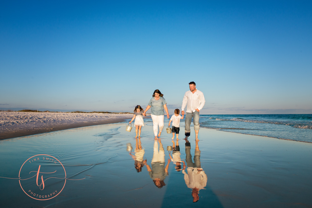 destin family walking down beach for photography