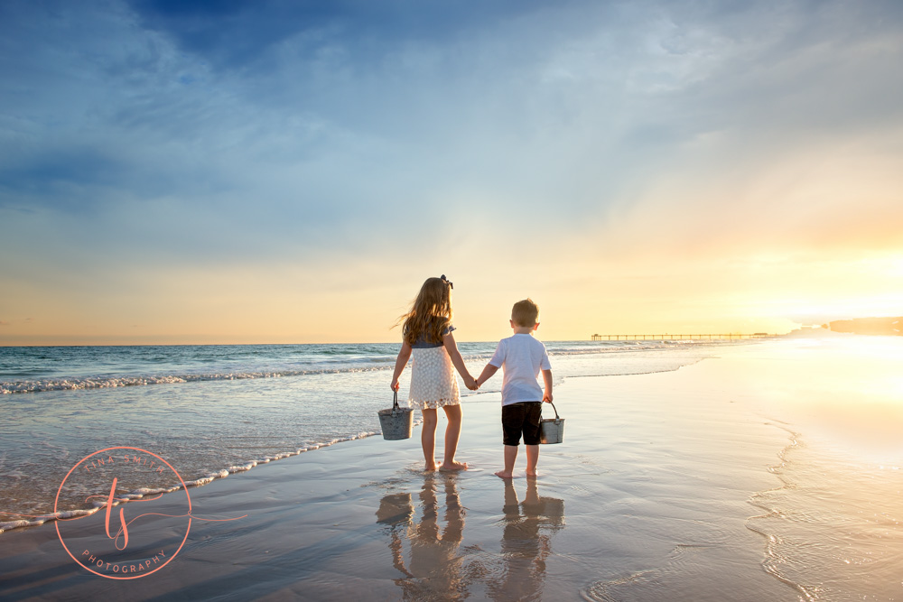 children walking down beach in destin at sunset