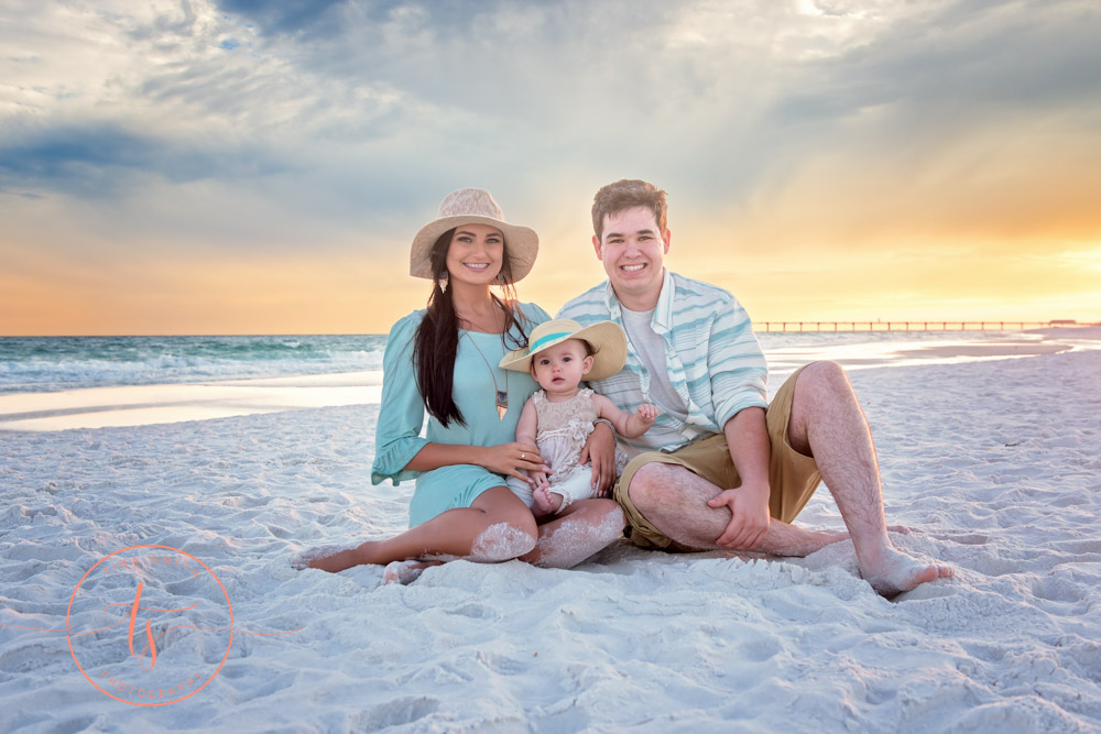 family sitting on beach in destin