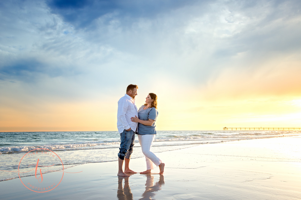 couple standing on beach in destin at sunset