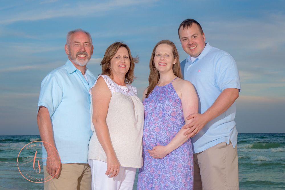 family posing on beach