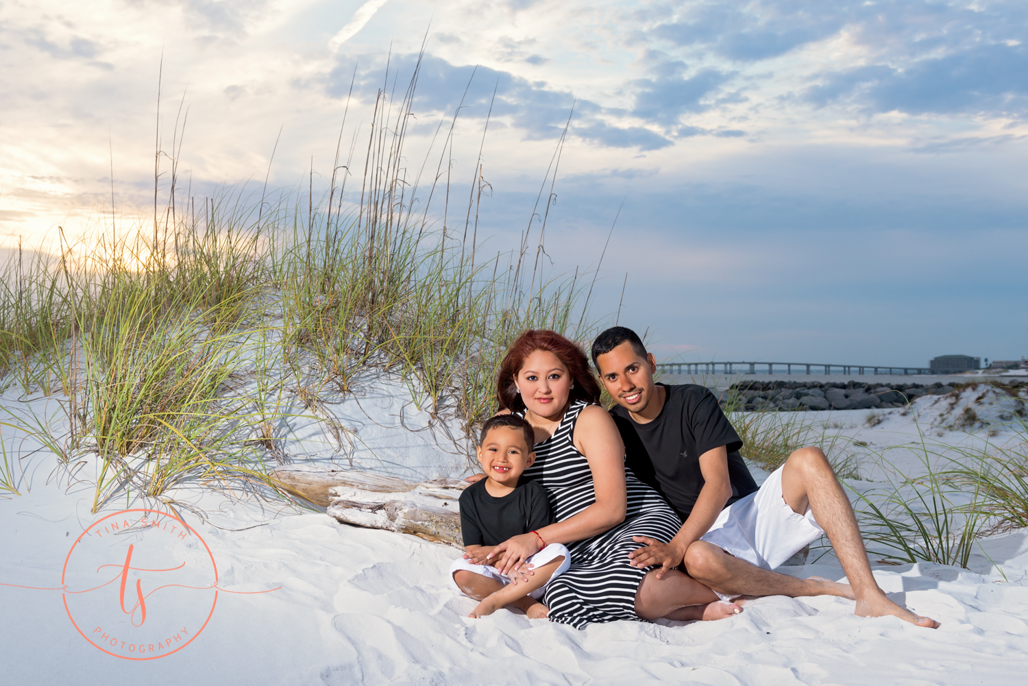 mom dad and son pose for maternity picture on beach in destin