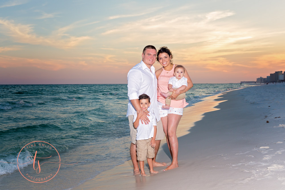 family posing on beach for destin photographer
