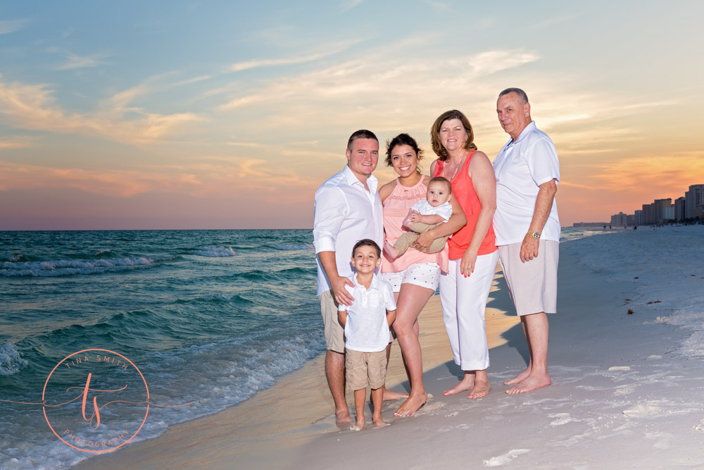 family on beach at sunset posing for destin photographer