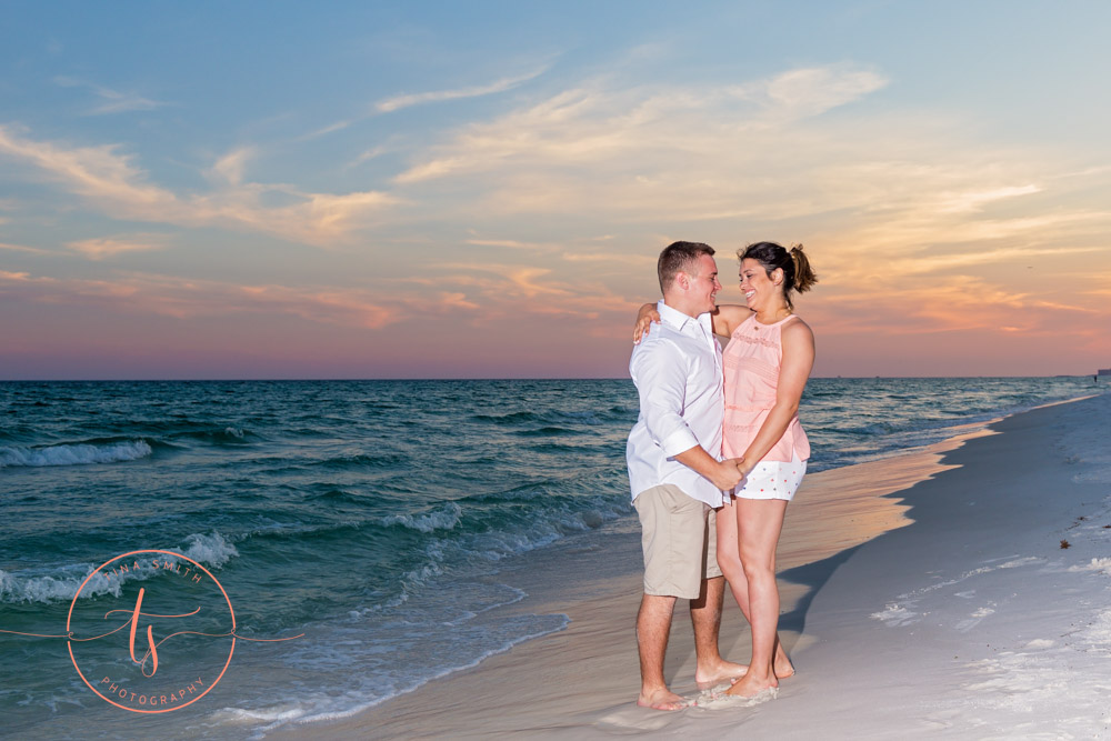 couple on beach posing for destin photographer at sunset