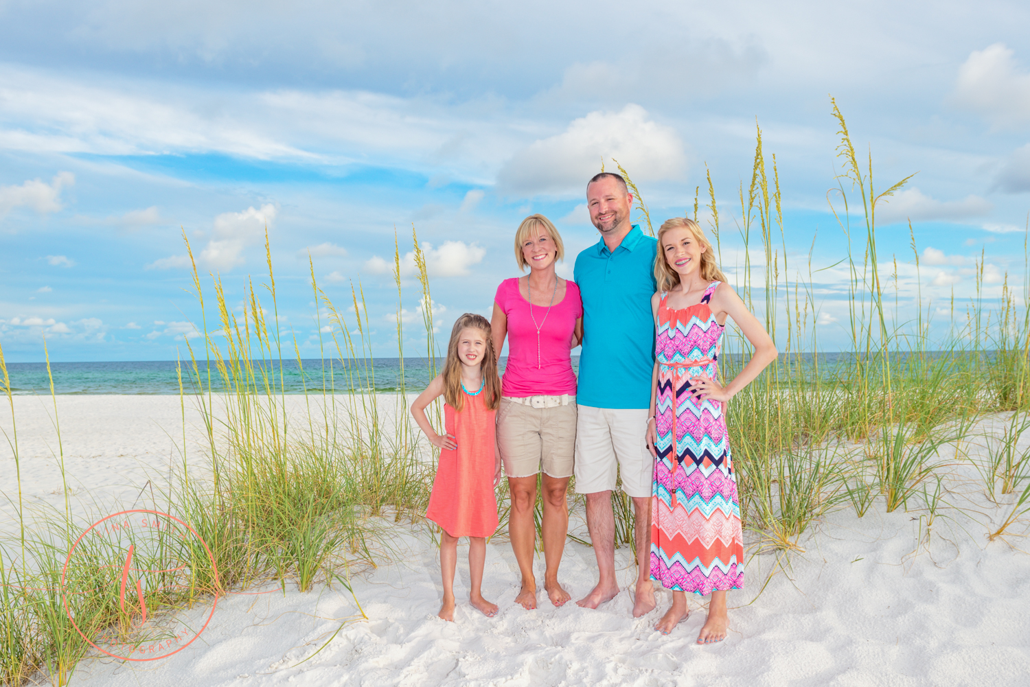 family standing in front of sea oats on the beach is destin for family photography