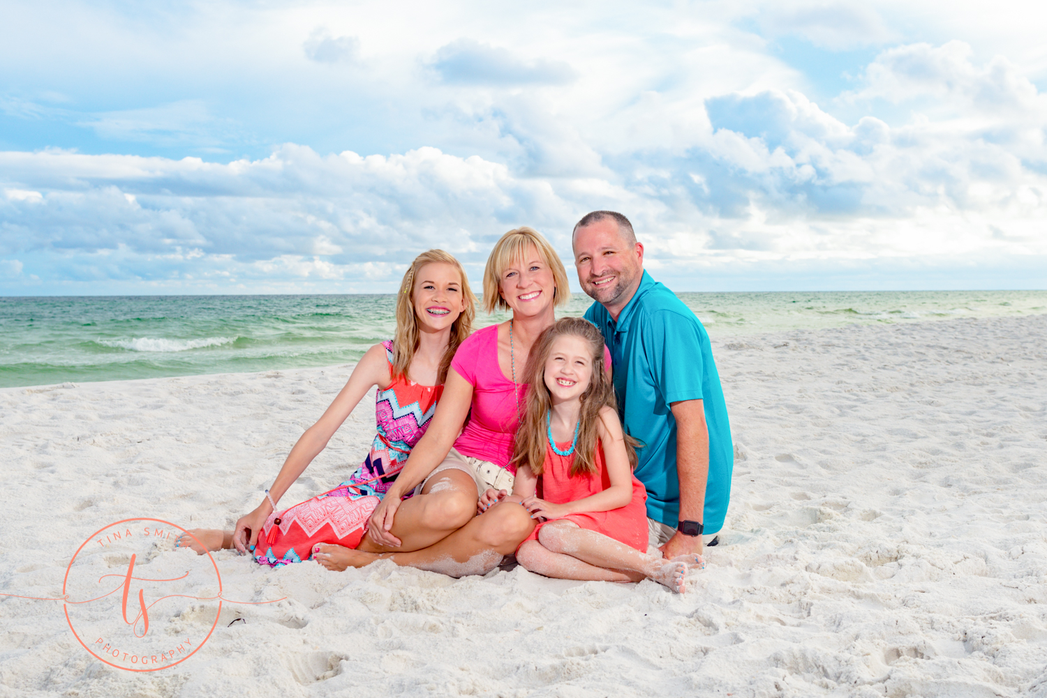 family sitting on the beach for destin family beach photographer