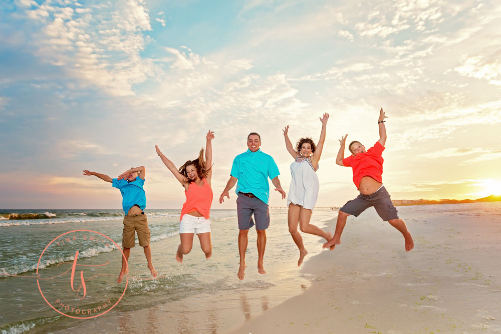 family jumping in the air on destin beach