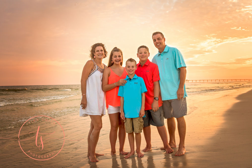 destin family beach photography posing at sunset in the waters edge