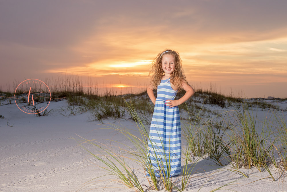 girl standing on beach at sunrise