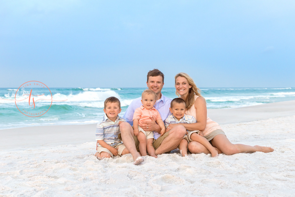 family sitting on the beach in destin