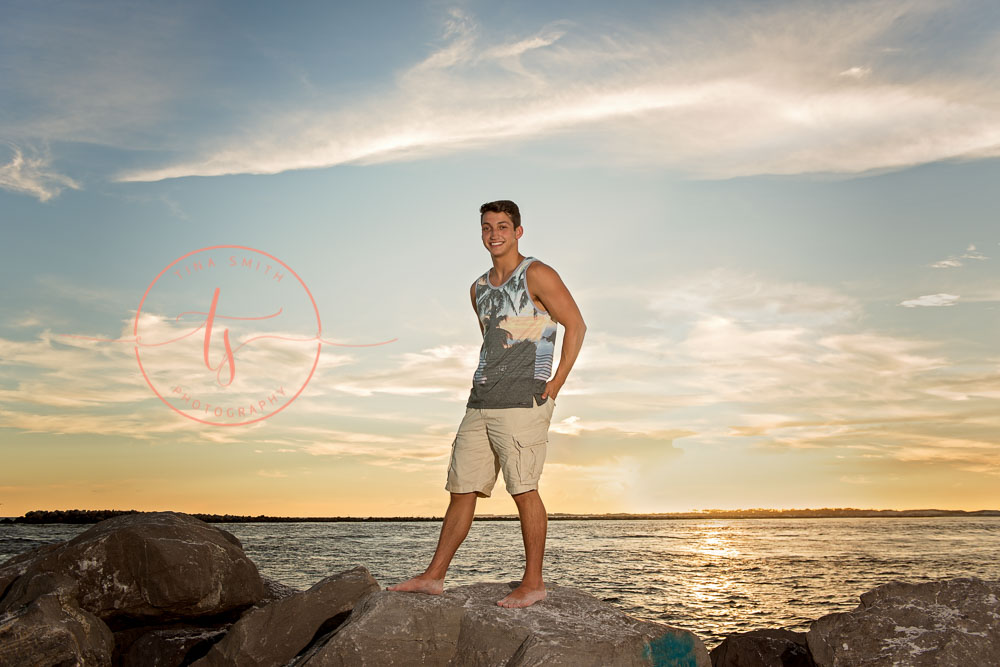 destin senior portraits photographer boy standing on the jetties