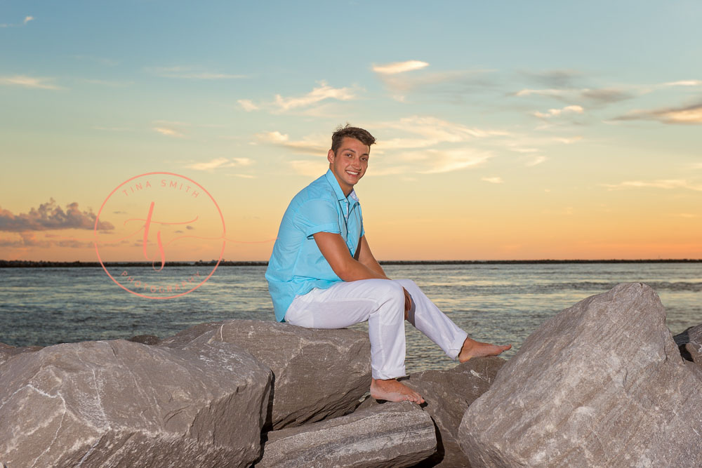 destin senior portraits photographer boy sitting on the jetties