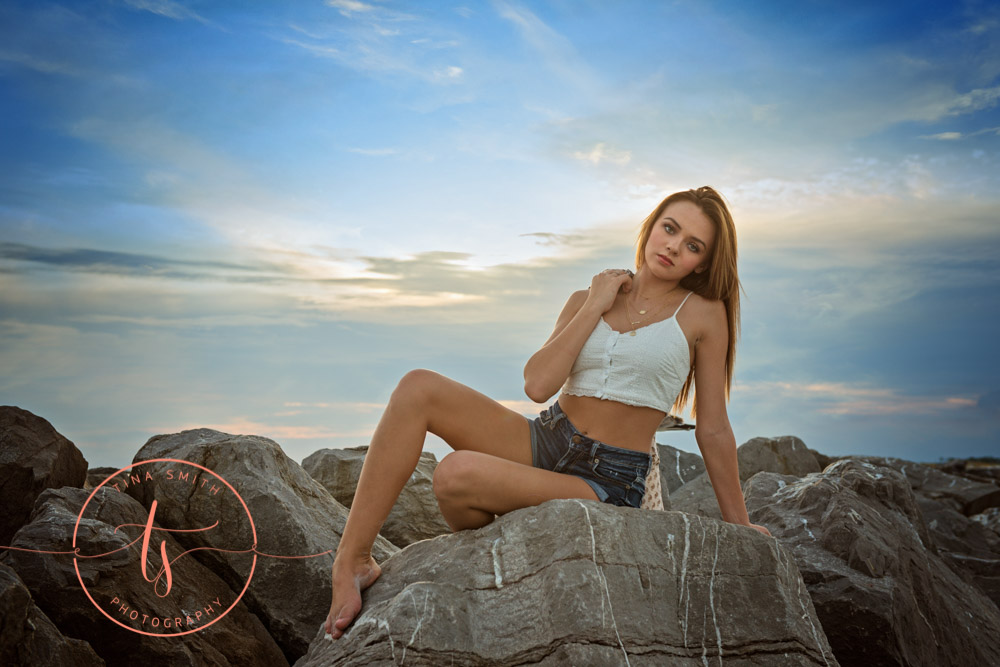 senior girl posing on rock in destin
