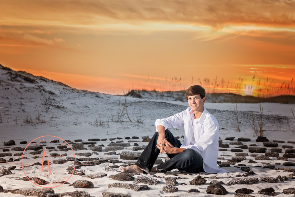 senior boy sitting in a ring of stones ft walton beach