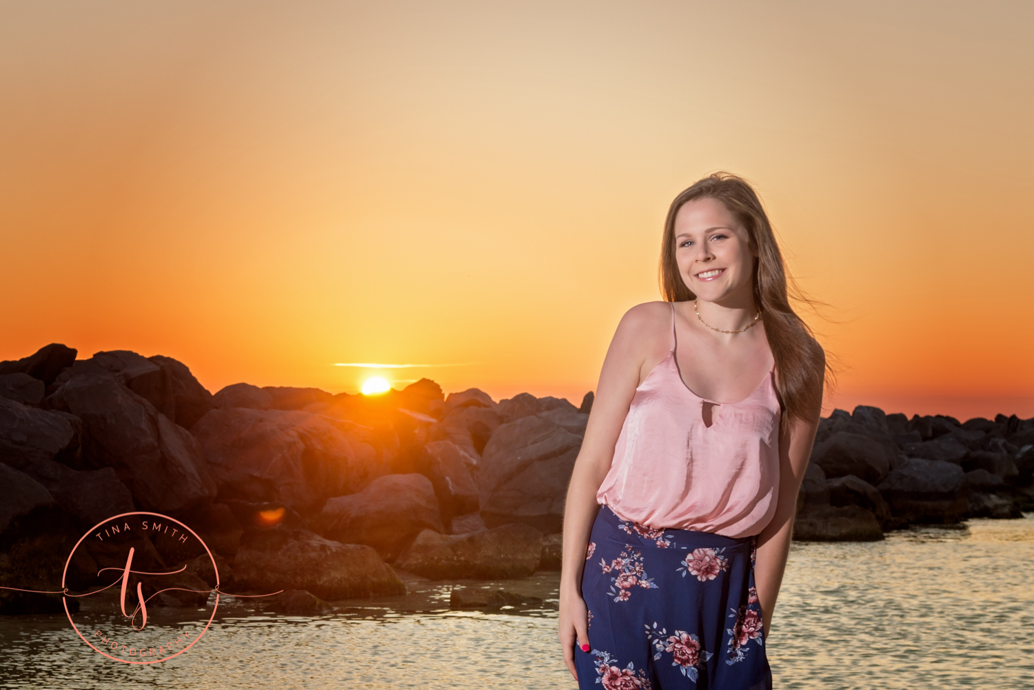 destin senior posing infant of water at sunset 