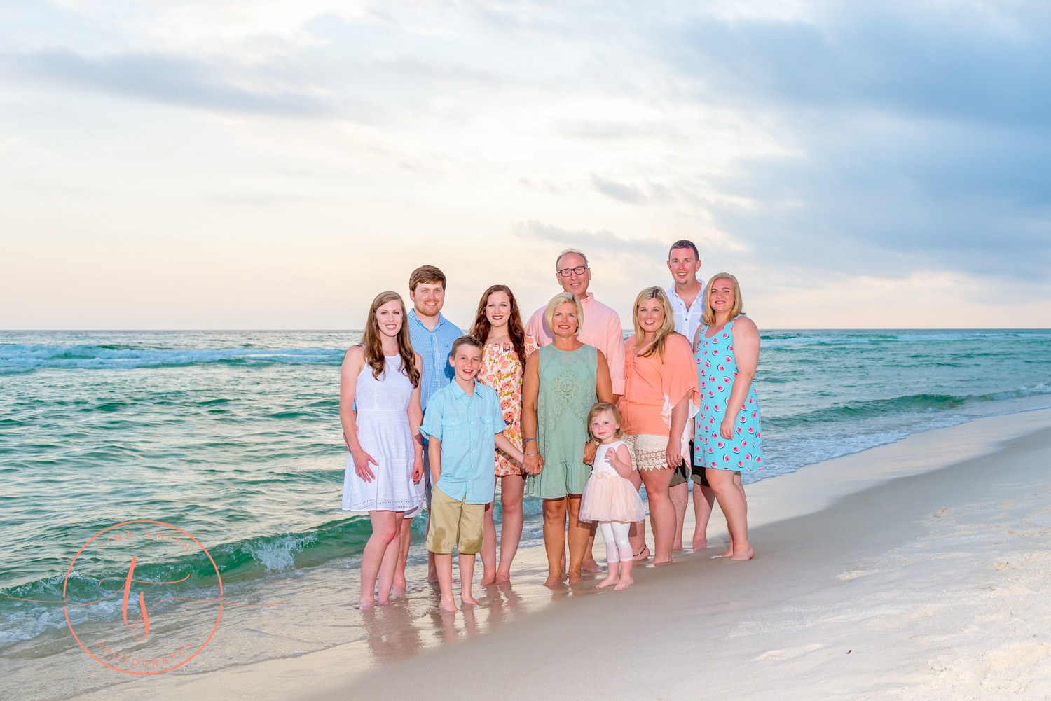 family standing in the water at seacrest beach for photography 