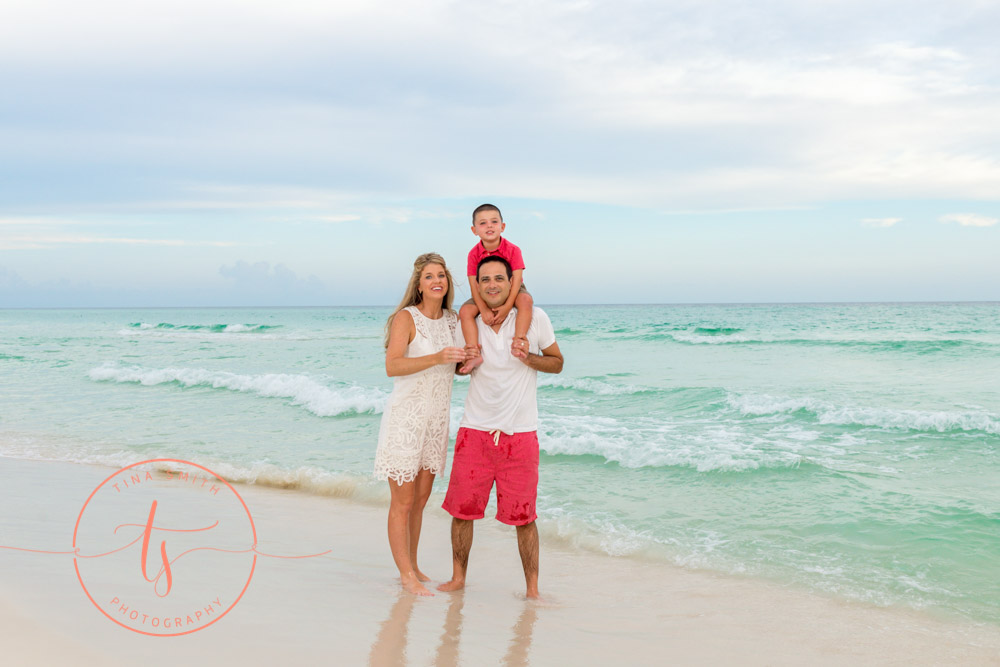 family posing on beach in seacrest